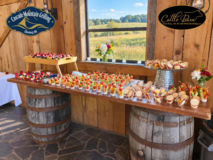 Appetizers displayed on barrels near the barn windows
